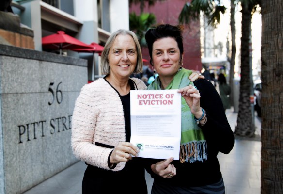 Greens Senator Lee Rhiannon (left) and Natalie Lowry (right) flash an eviction notice for Lynas in Sydney. (Photo: Supplied)