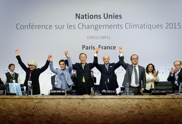 PARIS, FRANCE - DECEMBER 12: Executive Secretary of the United Nations Framework Convention on Climate Change (UNFCCC) Christiana Figueres (L 2), Secretary General of the United Nations Ban Ki Moon (C), Foreign Affairs Minister and President-designate of COP21 Laurent Fabius (R 2), and France's President Francois Hollande (R) raise hands together after adoption of a historic global warming pact at the COP21 Climate Conference in Le Bourget, north of Paris, on December 12, 2015. (Photo by Arnaud BOUISSOU/COP21/Anadolu Agency/Getty Images)