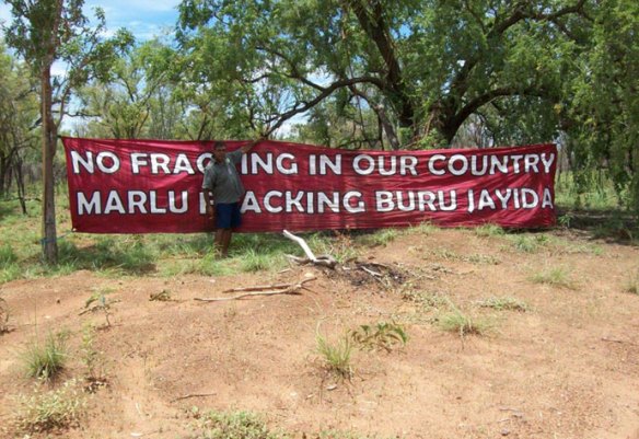 Protestors hang the banner to stop Buru Energy from fracking. (Photo: Supplied)